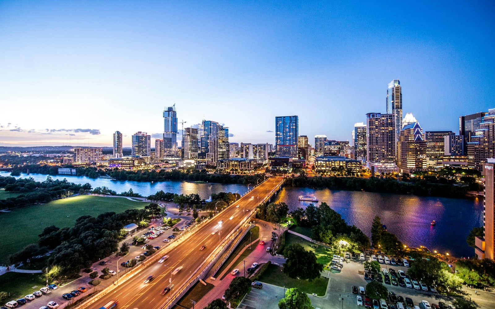 The Austin, Texas skyline glowing at dusk over the river.